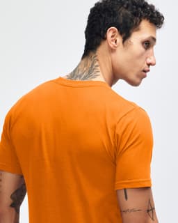 An orange short sleeve t-shirt displayed on a model, featuring a logo on the back.