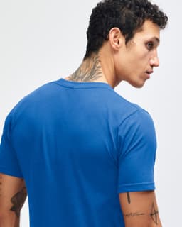 A blue short sleeve t-shirt featuring a crew neck and a small branding logo on the back.