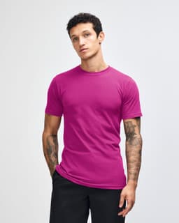 A unisex fine jersey short sleeve t-shirt in a vibrant purple colour, displayed on a model. It features a branding logo.