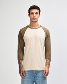 A unisex raglan T-shirt featuring a cream body with olive green sleeves, along with a logo on the front.