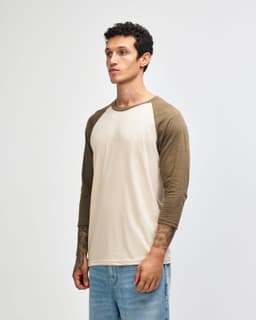 A unisex raglan T-shirt featuring a beige body with brown 3/4 sleeves and a logo.