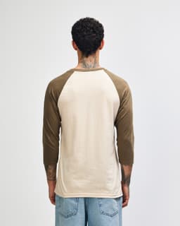 A unisex raglan T-shirt featuring a beige body and brown sleeves, with a plain design and no visible logo.