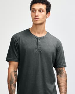 A unisex henley t-shirt in dark grey, featuring short sleeves and a buttoned neckline. Includes a logo.