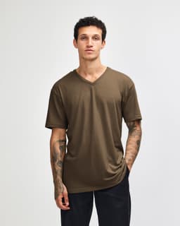 A unisex olive green V-neck t-shirt with short sleeves, displayed on a model. The shirt features a logo.