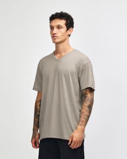 A unisex v-neck t-shirt in a light grey colour, featuring a simple design and a logo on the side.