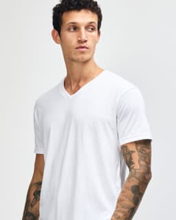 A white unisex V-neck T-shirt featuring short sleeves, displayed on a model. The shirt has a simple design with no visible logos.