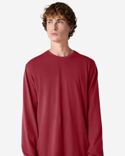 A long sleeve T-shirt in red, featuring a simple design and a crew neck. It includes a logo on the fabric.