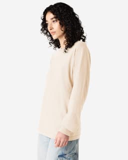 A long sleeve t-shirt in a light beige colour, featuring a logo on the front and a relaxed fit.
