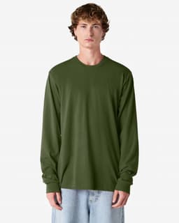 An olive green long sleeve T-shirt on a model, featuring a simple design and relaxed fit. The shirt has a logo.