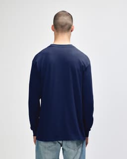 A navy blue long sleeve t-shirt for adults, featuring a simple design and a logo on the garment.
