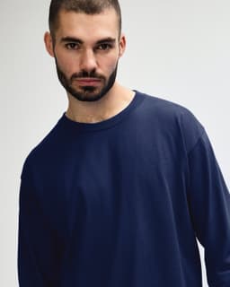 A navy long sleeve T-shirt designed for adults, displayed on a model with a neutral background.