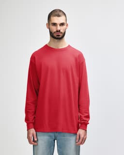 A red long sleeve T-shirt on a model standing against a plain background. The shirt features a logo.