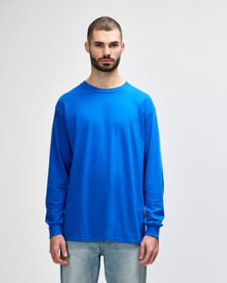 A vibrant blue long sleeve t-shirt with a crew neck, featuring a branded logo on the front.