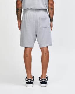 Grey unisex gym shorts with an elastic waistband and a back pocket, featuring a logo.