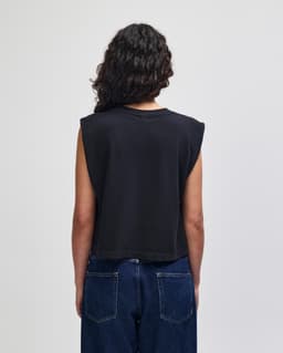 A women's muscle T-shirt in dark grey with a cropped design and sleeveless style. It features a logo on the back.