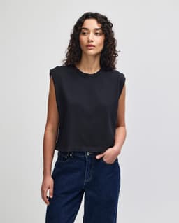 A dark grey women's muscle t-shirt featuring a relaxed fit and a branding logo.