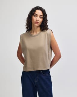 A women's muscle t-shirt in a muted olive green colour, featuring wide armholes and a casual fit. It includes a logo.