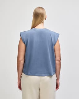 A women's muscle T-shirt in a dark blue shade, featuring short sleeves and a cropped design, with branding on the back.