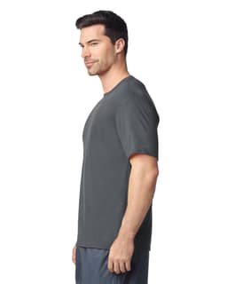 A grey Gildan Performance adult T-shirt displayed on a male model, featuring a logo on the shirt.