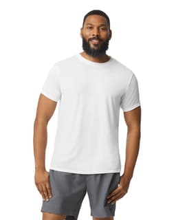 A white Gildan Performance adult t-shirt displayed on a model, paired with grey shorts and featuring a logo.