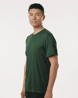 A man wearing a green performance t-shirt, featuring a fitted design and short sleeves. The shirt has a logo.