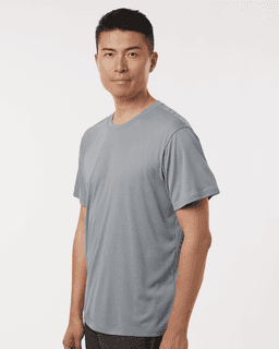 A man wearing a grey performance T-shirt featuring a logo. The shirt has a comfortable, relaxed fit.