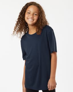 A navy blue Youth Pro-Lock Performance T-Shirt displayed on a smiling child with curly hair. It has a simple design and loose fit.