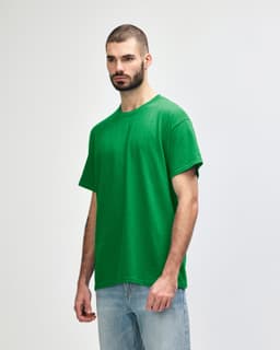 A green Gildan Heavy Cotton adult T-shirt displayed on a model against a plain background.