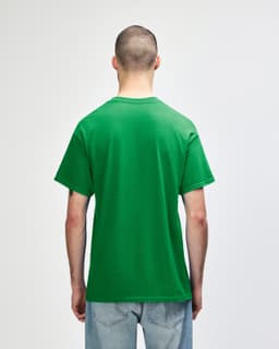 A green Gildan Heavy Cotton adult t-shirt viewed from the back, featuring a plain design and a logo.