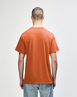 A back view of an orange Gildan Heavy Cotton Adult T-Shirt, featuring a simple design.