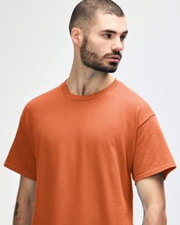 A red Gildan Heavy Cotton adult T-shirt displayed on a model with a casual pose and a blank background.