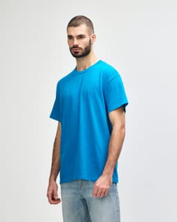 A blue Gildan Heavy Cotton adult t-shirt displayed on a model, featuring a simple design and a logo.