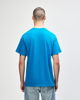 A blue Gildan Heavy Cotton Adult T-Shirt displayed from the back, featuring short sleeves and a logo.