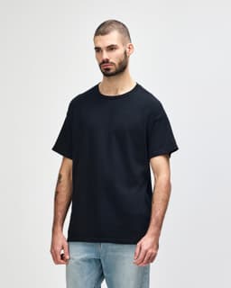 A black Gildan Heavy Cotton Adult T-Shirt displayed on a male model, featuring a simple logo.