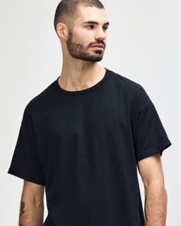 A black Gildan Heavy Cotton Adult T-Shirt featuring a classic design and a logo on the front.