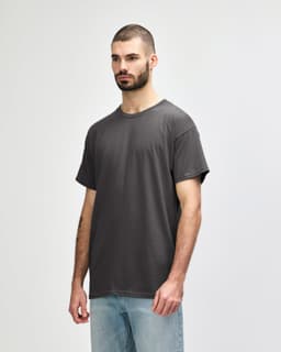 A light grey Gildan Heavy Cotton adult t-shirt displayed on a male model against a plain background.