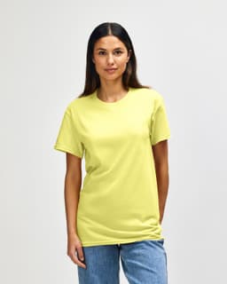 A yellow Gildan Heavy Cotton Adult T-Shirt is worn by a man standing against a plain background.