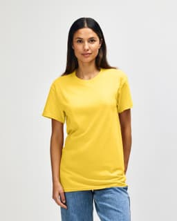 A yellow Gildan Heavy Cotton Adult T-Shirt displayed on a model, featuring a simple design and a logo.