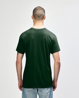 A dark green Gildan Heavy Cotton Adult T-Shirt displayed on a male model from the back, featuring a logo.