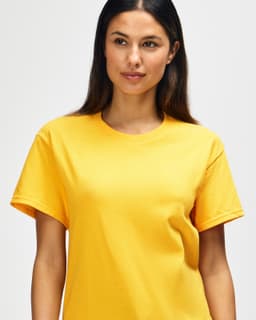 A yellow Gildan Heavy Cotton adult t-shirt displayed on a male model. The shirt has a simple design and a logo.