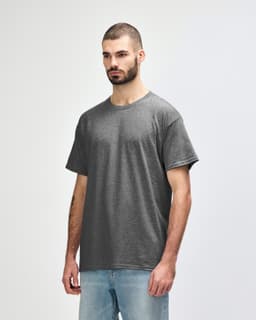 A grey Gildan Heavy Cotton adult t-shirt displayed on a model, featuring a simple design and a logo.