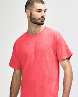 A red Gildan Heavy Cotton Adult T-Shirt on a model, featuring a simple design and a crew neck.