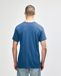 A blue Gildan Heavy Cotton Adult T-Shirt is displayed from the back, featuring a simple design and a logo.
