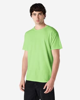 A man wearing a bright green Gildan Heavy Cotton Adult T-Shirt, with a blank design and a logo on the sleeve.