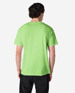 A man wearing a bright green Gildan Heavy Cotton Adult T-Shirt, viewed from the back. The shirt has a logo on it.