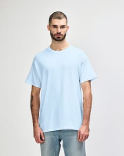 A light blue Gildan Heavy Cotton adult T-shirt displayed on a male model. The shirt has a logo on it.