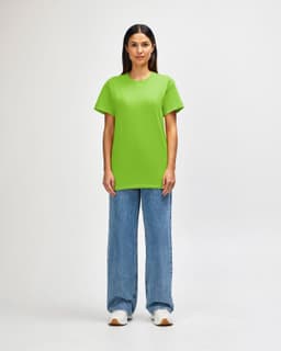 A green Gildan Heavy Cotton adult T-shirt is displayed on a model, paired with light blue jeans.