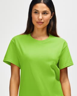 A man wearing a bright lime green Gildan Heavy Cotton adult t-shirt featuring a round neckline and visible branding.
