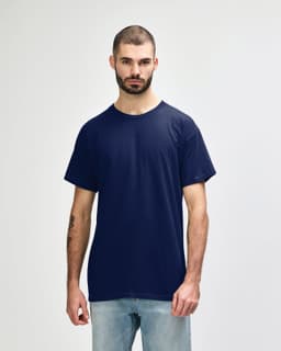 A navy Gildan Heavy Cotton adult t-shirt displayed on a model, featuring a plain design and short sleeves.