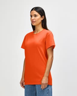 An orange Gildan Heavy Cotton adult T-shirt displayed on a male model. The shirt has a simple design and features a logo.